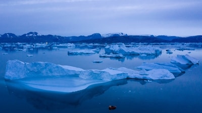 A boat navigates at night next to large icebergs near the town of Kulusuk, in eastern Greenland on Aug. 15, 2019. (AP) A boat navigates at night next to large icebergs near the town of Kulusuk, in eastern Greenland on Aug. 15, 2019. (AP)