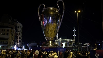 Fans in front of a replica Champions League trophy ahead of the final. (REUTERS)