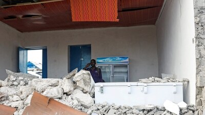 A Somali police officer uses his cell phone inside the rubble of the Pearl Beach Restaurant following an attack by Al Shabaab militants at the Liido beach in Mogadishu, Somalia June 10, 2023. (Reuters)