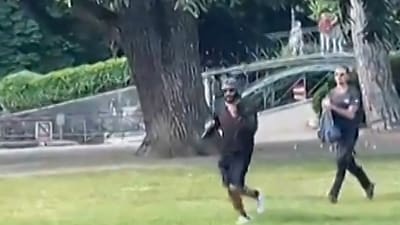 A screen grab taken from a video obtained by AFPTV on June 8, 2023 shows a man armed with a knife running away after he attacked a group of pre-school children playing by a lake in the French Alps city of Annecy. (AFP) A screen grab taken from a video obtained by AFPTV on June 8, 2023 shows a man armed with a knife running away after he attacked a group of pre-school children playing by a lake in the French Alps city of Annecy. (AFP)