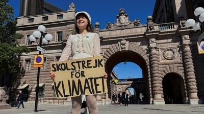 Greta Thunberg stands with a sign that reads, "School Strike for climate", outside the Swedish Parliament on the day of her weekly protest in Stockholm, Sweden. (Reuters)