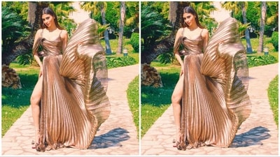 Her metallic-coloured dress boasts a plunging neckline, delicate noodle straps, a fitted bust, and a flared hemline, accentuated by a daring thigh-high slit. (Instagram/@imouniroy) Her metallic-coloured dress boasts a plunging neckline, delicate noodle straps, a fitted bust, and a flared hemline, accentuated by a daring thigh-high slit. (Instagram/@imouniroy)