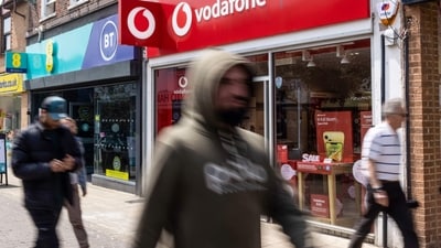 Pedestrians pass a Vodafone Group Plc store in Hove, UK, on Monday. (Bloomberg) Pedestrians pass a Vodafone Group Plc store in Hove, UK, on Monday. (Bloomberg)