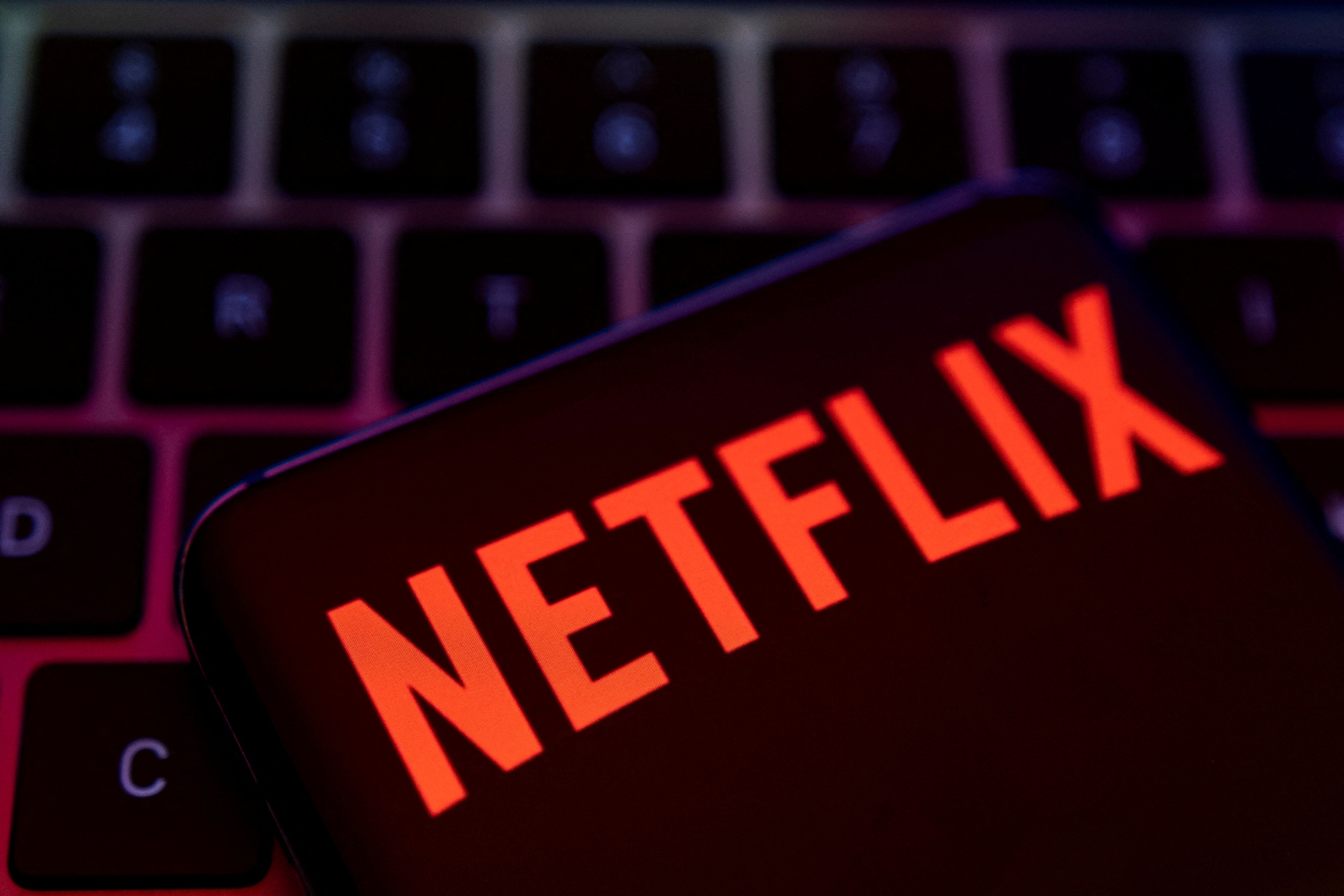 According to Netflix's new password-sharing policies, the subscribers will have to pay an extra $7.99 ( ₹658) for sharing their accounts with up to two more people living outside the household. (Reuters file photo)