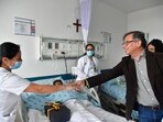 Colombia's President Gustavo Petro greets a nurse tending to one of the four Indigenous children who survived an Amazon plane crash that killed three adults and then braved the jungle for 40 days before being found alive, at a military hospital in Bogota, Colombia