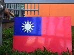 A worker holds Taiwan's flag. A worker holds Taiwan's flag.