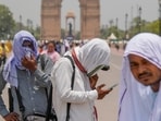 Photographers cover themselves with scarves during a hot summer afternoon, at the India Gate, in New Delhi, Saturday, Photographers cover themselves with scarves during a hot summer afternoon, at the India Gate, in New Delhi, Saturday,