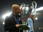 Manchester City manager Pep Guardiola celebrates with the trophy after winning the Champions League
