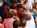 Serbia's Novak Djokovic celebrates with his team after winning the final against Norway's Casper Ruud