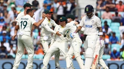Scott Boland celebrates after taking the wicket of India's Virat Kohli with teammates (Action Images via Reuters)
