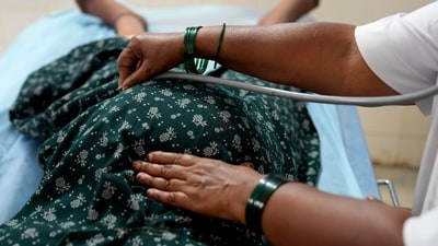A senior nurse uses a stethoscope to examine a 25-year-old who is nine months pregnant, at a government maternity hospital which runs on rooftop solar power, in Raichur. (AP) A senior nurse uses a stethoscope to examine a 25-year-old who is nine months pregnant, at a government maternity hospital which runs on rooftop solar power, in Raichur. (AP)