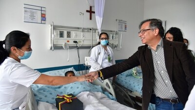 Colombia's President Gustavo Petro greets a nurse tending to one of the four Indigenous children who survived an Amazon plane crash that killed three adults and then braved the jungle for 40 days before being found alive, at a military hospital in Bogota, Colombia (AP)