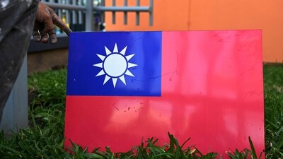 A worker holds Taiwan's flag. (AFP) A worker holds Taiwan's flag. (AFP)