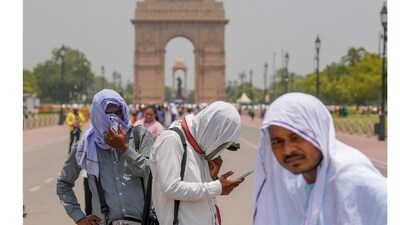 Photographers cover themselves with scarves during a hot summer afternoon, at the India Gate, in New Delhi, Saturday, (PTI) Photographers cover themselves with scarves during a hot summer afternoon, at the India Gate, in New Delhi, Saturday, (PTI)