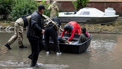 Emergency teams help rush to safety injured civilian evacuees. (AP) Emergency teams help rush to safety injured civilian evacuees. (AP)