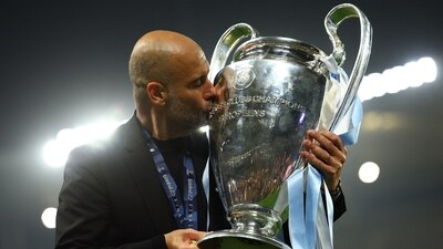 Manchester City manager Pep Guardiola celebrates with the trophy after winning the Champions League (REUTERS)