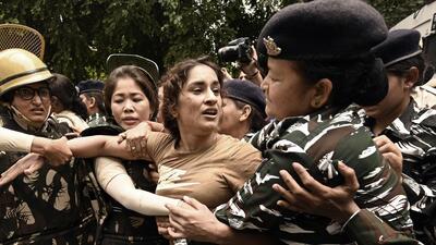 Security personnel detain wrestler Vinesh Phogat during wrestlers' protest march towards new Parliament building, in New Delhi (Sanjeev Verma/ HT) Security personnel detain wrestler Vinesh Phogat during wrestlers' protest march towards new Parliament building, in New Delhi (Sanjeev Verma/ HT)