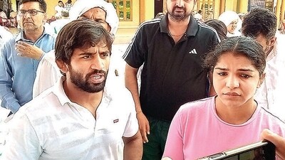 Wrestlers Bajrang Punia and Sakshi Malik in Sonepat on Saturday. (PTI)