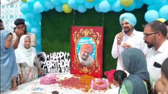 Sidhu Moose Wala’s parents at a function to mark 30th birthday of the slain singer, at Moosa village in Mansa on Sunday. (HT File)