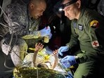 Soldiers of the Colombian Air Force give medical attention inside a plane to the surviving children of a Cessna 206 plane crash in the thick jungle, while they are transferred to Bogota by air in San Jose del Guaviare, Colombia, June 9, 2023. 
