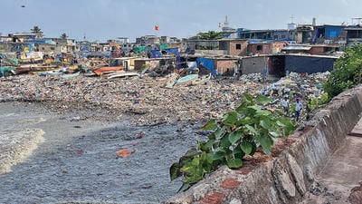Mumbai, India - June 12, 2023: A view of the seashore littered with plastic garbage and small fishing boats parked with slums in the background during high tide, at Darya Nagar, Jamshedji Bunder, Colaba, in Mumbai, India, on Monday, June 12, 2023. (Photo by Bhushan Koyande/HT Photo) (HT PHOTO) Mumbai, India - June 12, 2023: A view of the seashore littered with plastic garbage and small fishing boats parked with slums in the background during high tide, at Darya Nagar, Jamshedji Bunder, Colaba, in Mumbai, India, on Monday, June 12, 2023. (Photo by Bhushan Koyande/HT Photo) (HT PHOTO)