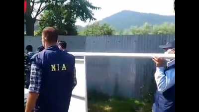 NIA officials accompanied by local police and arrived at Baghatpora Handwara and attached land. (HT Photo) NIA officials accompanied by local police and arrived at Baghatpora Handwara and attached land. (HT Photo)
