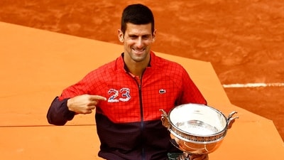 Serbia's Novak Djokovic poses with the trophy after winning the French Open and his 23rd Grand Slam. (REUTERS)