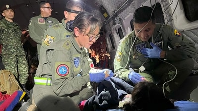 TOPSHOT - This handout picture taken on June 9, 2023 released by the Colombian Air Force shows members of the Colombian Army checking one of the four Indigenous children who were found alive after being lost for 40 days in the Colombian Amazon rainforest following a plane crash in San Jose del Guaviare during their transfer to Bogota. Exhausted but happy, four Indigenous children who had been missing for more than a month in the Colombian Amazon rainforest were reunited with their relatives Saturday, in a happy ending to a nerve-racking saga that gripped the nation. (AFP PHOTO / COLOMBIAN AIR FORCE)