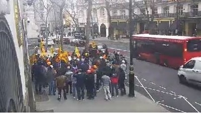 A screengrab shows men with Khalistani flags outside Indian high commission in London on March 19. (Screengrab from video sourced by ANI)