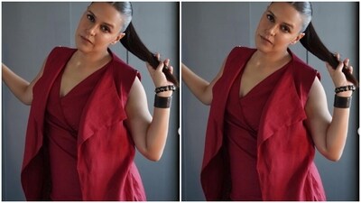 Featuring a plunging neckline and sleeveless details, Neha's red dress came with a thigh high slit and a matching sleeveless shrug. (Instagram/@nehadhupia) Featuring a plunging neckline and sleeveless details, Neha's red dress came with a thigh high slit and a matching sleeveless shrug. (Instagram/@nehadhupia)