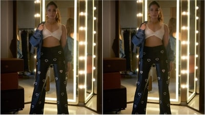 Her ensemble showcases a white bralette top with knot detailing, complemented by dark blue denim pants adorned with white hearts all over. To add a touch of chicness, she layered a blue denim shirt over her outfit, completing her stylish look. (Instagram/@tamannaahspeaks) Her ensemble showcases a white bralette top with knot detailing, complemented by dark blue denim pants adorned with white hearts all over. To add a touch of chicness, she layered a blue denim shirt over her outfit, completing her stylish look. (Instagram/@tamannaahspeaks)