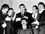 American speed skating champion Terry McDermott, background center, a barber by trade, prepares to take a swipe at the famed locks of Beatle Paul McCartney, seated , to the mock horror of the other Beatles and TV host Ed Sullivan, during rehearsals at the TV Studio, New York, Feb. 9, 1964. From left, George Harrison, Ringo Starr, McDermott, Ed Sullivan and John Lennon. McDermott, who won the only gold medal for the United States at the 1964 Winter Olympics, died on Saturday, May 20, 2023, U.S. Speedskating said. He was 82.