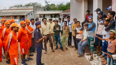 National Disaster Response Force (NDRF) personnel brief citizens ahead of cyclone Biparjoy’s landfall, at Mandvi, in Kutch, on June 12. A warning has been issued for extremely heavy rainfall accompanied by strong winds in coastal parts of the Saurashtra-Kutch region, especially in the districts of Kutch, Porbandar, and Devbhumi Dwarka, reported PTI. (PTI) National Disaster Response Force (NDRF) personnel brief citizens ahead of cyclone Biparjoy’s landfall, at Mandvi, in Kutch, on June 12. A warning has been issued for extremely heavy rainfall accompanied by strong winds in coastal parts of the Saurashtra-Kutch region, especially in the districts of Kutch, Porbandar, and Devbhumi Dwarka, reported PTI. (PTI)