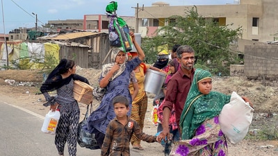 Villagers are seen leaving Jakhau village during an evacuation ahead of cyclone Biparjoy’s landfall, in the Kutch district, Gujarat on June 12. (PTI) Villagers are seen leaving Jakhau village during an evacuation ahead of cyclone Biparjoy’s landfall, in the Kutch district, Gujarat on June 12. (PTI)