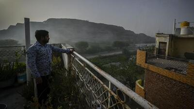 A resident of Mulla Colony, located opposite the Ghazipur landfill, watches smoke emanating from the garbage dump. (Raj K Raj/HT Photo) A resident of Mulla Colony, located opposite the Ghazipur landfill, watches smoke emanating from the garbage dump. (Raj K Raj/HT Photo)