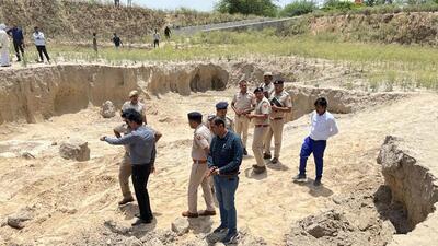 Gurugram: Police personnel and other officials inspects a land where three women labourers were killed while four others were critically injured after being trapped in a mudslide while digging a pond at Pataudi, in Gurugram, Tuesday, June 13, 2023. (PTI Photo) (PTI06_13_2023_000264B) (PTI) Gurugram: Police personnel and other officials inspects a land where three women labourers were killed while four others were critically injured after being trapped in a mudslide while digging a pond at Pataudi, in Gurugram, Tuesday, June 13, 2023. (PTI Photo) (PTI06_13_2023_000264B) (PTI)