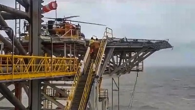 Indian Coast Guard's (ICG) ALH Mk-III (CG 858) helicopter airlifts 11 personnel from jack-up rig 'Key Singapore' operating off Dwarka to Okha, in Dwarka, Monday, June 12, 2023. (PTI) Indian Coast Guard's (ICG) ALH Mk-III (CG 858) helicopter airlifts 11 personnel from jack-up rig 'Key Singapore' operating off Dwarka to Okha, in Dwarka, Monday, June 12, 2023. (PTI)