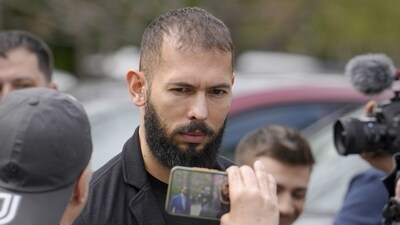 Andrew Tate looks at a man filming with a mobile phone as he leaves the Bucharest Tribunal, in Bucharest, Romania, (AP) Andrew Tate looks at a man filming with a mobile phone as he leaves the Bucharest Tribunal, in Bucharest, Romania, (AP)