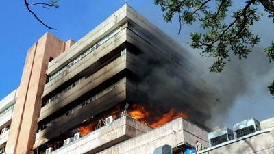 Smoke and flames billow out of the Satpura Bhawan that caught a massive fire, in Bhopal on Monday. (ANI) Smoke and flames billow out of the Satpura Bhawan that caught a massive fire, in Bhopal on Monday. (ANI)