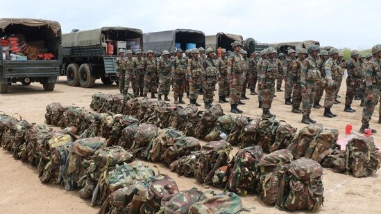 Indian Army soldiers stand before leaving for Kandla port to carry out an evacuation operation following the cyclonic storm Biparjoy, at a district headquarters in Bhuj, Gujarat. The government said 17 teams of the National Disaster Response Force (NDRF) and 12 of the State Disaster Response Force (SDRF) are also on standby in affected districts of Devbhumi Dwarka, Rajkot, Jamnagar, Junagadh, Porbandar, Gir Somnath, Morbi, and Valsad, reported PTI.(Information Department Gujarat State/Handout via Reuters)