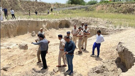 Gurugram: Police personnel and other officials inspects a land where three women labourers were killed while four others were critically injured after being trapped in a mudslide while digging a pond at Pataudi, in Gurugram, Tuesday, June 13, 2023. (PTI Photo) (PTI06_13_2023_000264B) (PTI)