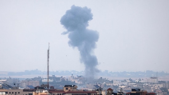 Smoke rises above buildings in Gaza city following an Israeli air strike on May 12, 2023. Israel and Gaza militants traded heavy fire on May 12, as hopes faded of securing a truce to end days of fighting that have killed dozens, all but one of them Palestinian. (Photo by Mahmud HAMS / AFP) (AFP)