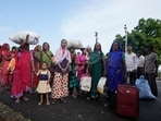 People wait for a bus to evacuate them from Jakhau village in Kutch district, India, Wednesday, People wait for a bus to evacuate them from Jakhau village in Kutch district, India, Wednesday,