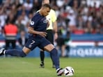 Paris St Germain's Kylian Mbappe takes a penalty