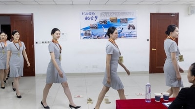 Applicants approach a panel of recruiters during a test session for cabin crew jobs at Hainan Airlines in Beijing, China. (Reuters)