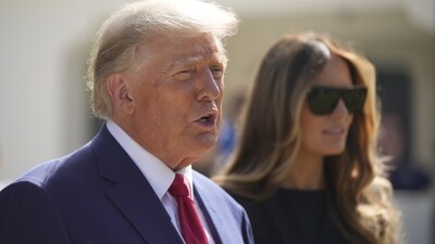 Former president Donald Trump talks to the media with Melania Trump. (AP) Former president Donald Trump talks to the media with Melania Trump. (AP)