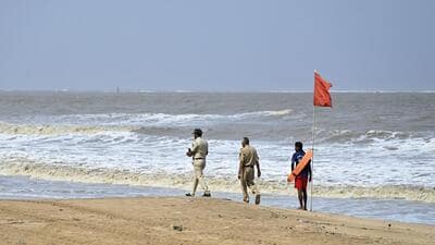 Mumbai, India - June 14, 2023: Police personnel and lifeguards stand guard at Juhu Beach to prevent people from venturing into the seawater after four teenagers were swept away by the raging waves as Cyclone Biporjoy intensified into an extremely severe cyclonic storm on June 11 and is expected to make landfall on June 15 in Gujarat, in Mumbai, India, on Wednesday, June 14, 2023. (Photo by Vijay Bate/HT Photo) (HT PHOTO) Mumbai, India - June 14, 2023: Police personnel and lifeguards stand guard at Juhu Beach to prevent people from venturing into the seawater after four teenagers were swept away by the raging waves as Cyclone Biporjoy intensified into an extremely severe cyclonic storm on June 11 and is expected to make landfall on June 15 in Gujarat, in Mumbai, India, on Wednesday, June 14, 2023. (Photo by Vijay Bate/HT Photo) (HT PHOTO)
