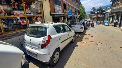 Doda: Brick bats scattered on vehicles and roads due to partial collapse a building after a massive earthquake struck Chenab region. (PTI) Doda: Brick bats scattered on vehicles and roads due to partial collapse a building after a massive earthquake struck Chenab region. (PTI)