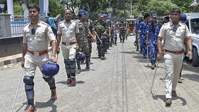 Police personnel walk past during a route march ahead of the state Panchayat poll, in Nadia. (PTI) Police personnel walk past during a route march ahead of the state Panchayat poll, in Nadia. (PTI)
