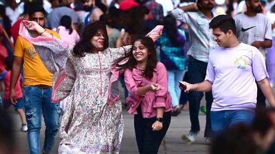 Residents brave the windy weather at Sukhna Lake in Chandigarh on Wednesday. (Keshav Singh/HT)